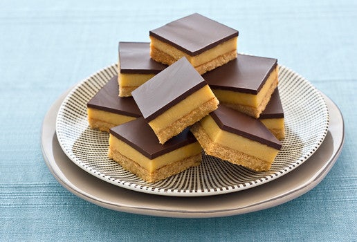 Caramel slices stacked on a plate